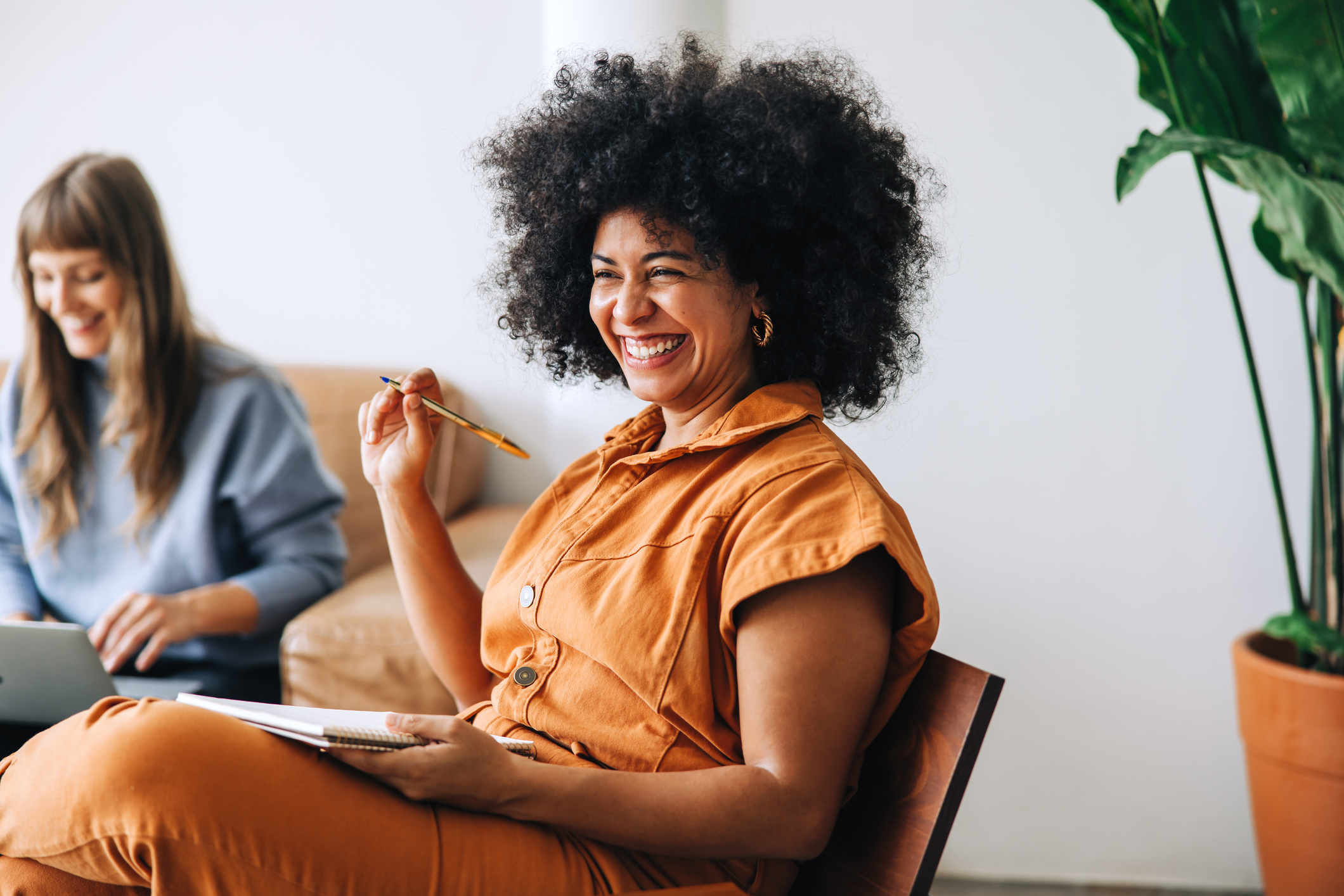 Happy young businesswomen working together in a modern workplace.