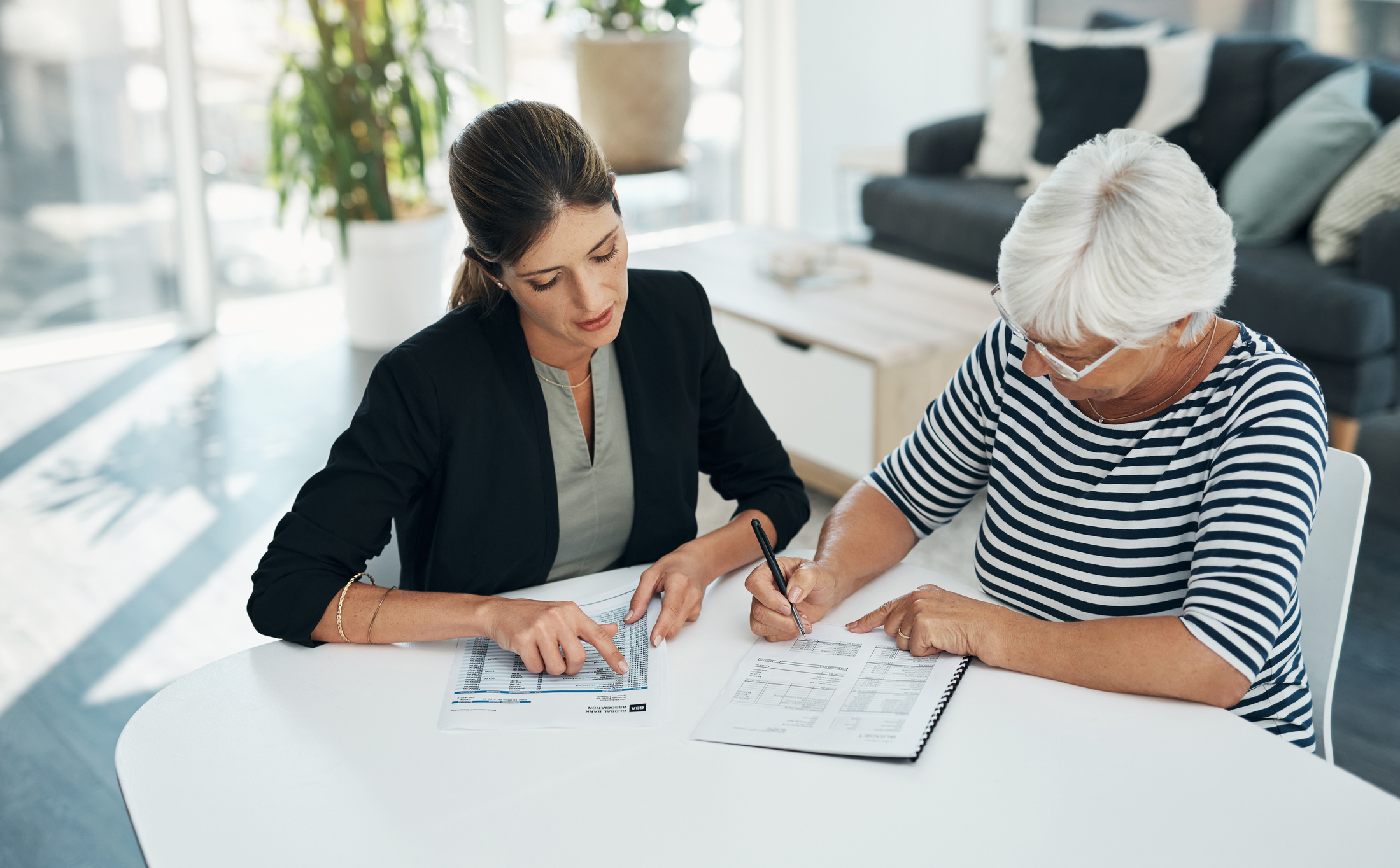 Signing, advisor and senior woman with contract for insurance, savings or retirement plan.